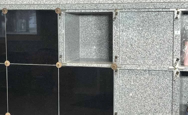 Open niche showing polished black exterior doors and grey granite privacy doors
