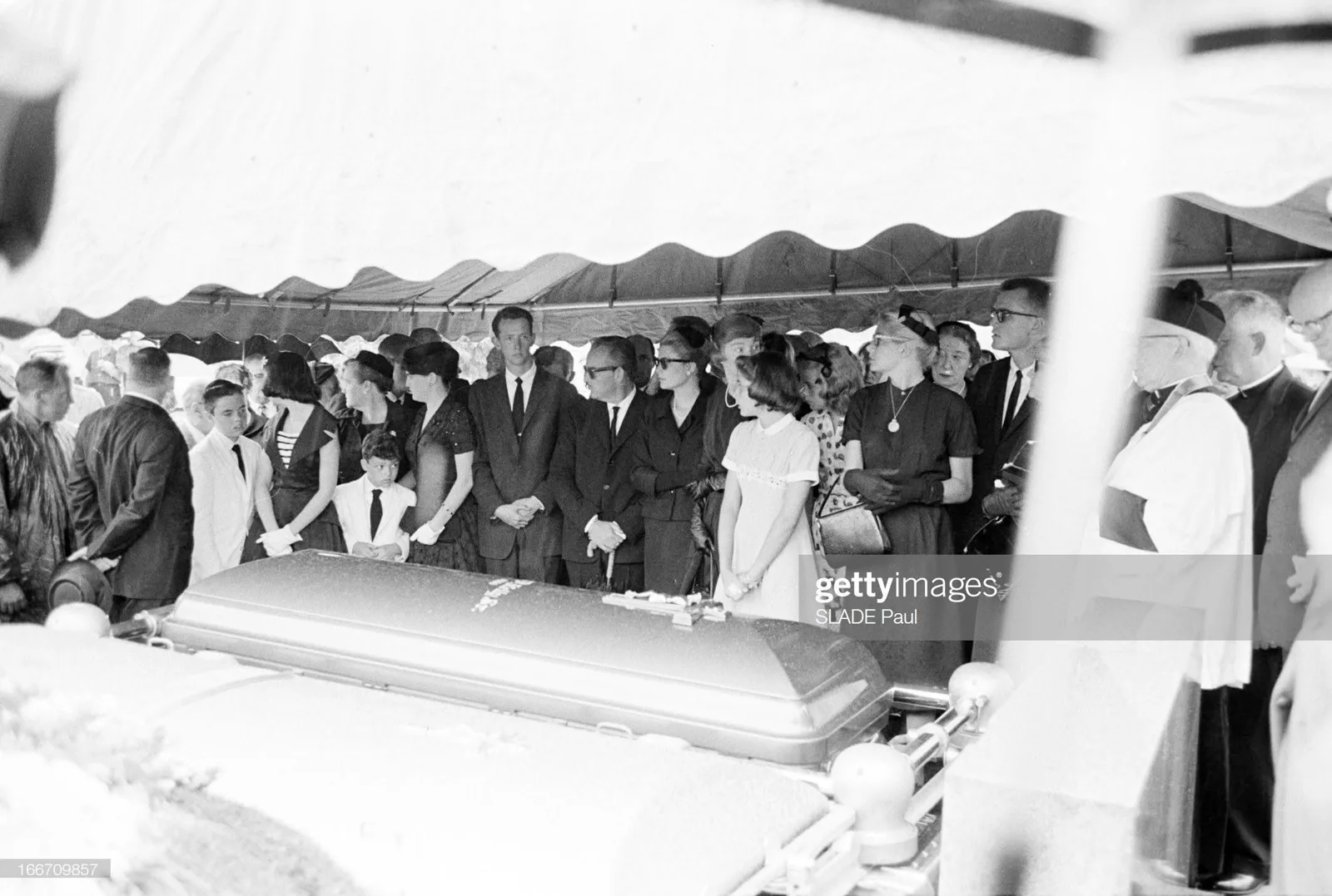 Princess Grace of Monaco, Prince Rainier III and Margaret Kelly under a tent at Holy Sepulchre Cemetery, with John B. Kelly Sr.&rsquo;s casket in front of them